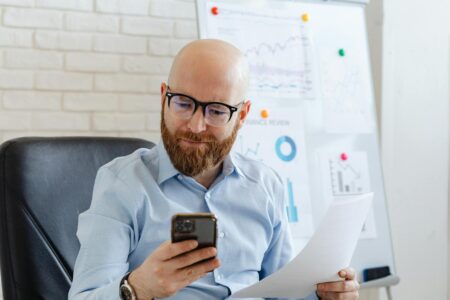 Person reading customer reviews on smartphone screen with Google Maps interface visible