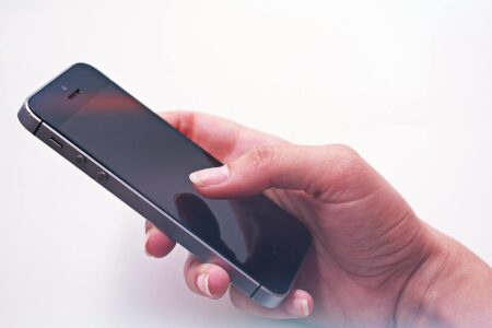 Person using smartphone to place restaurant order through mobile app
