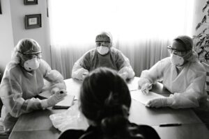 Business team meeting around conference table discussing crisis management strategy