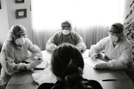 Business team meeting around conference table discussing crisis management strategy