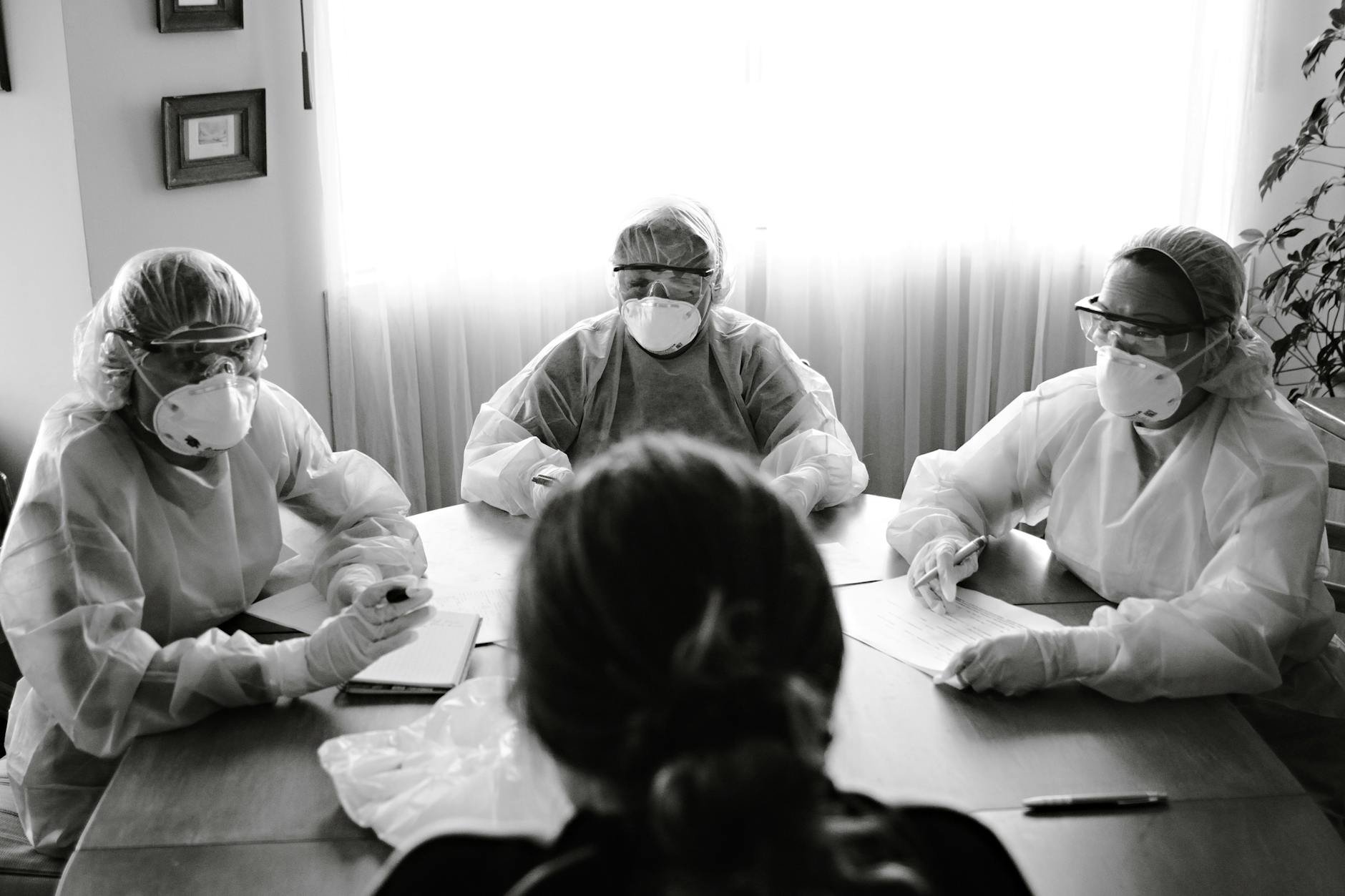 Business team meeting around conference table discussing crisis management strategy