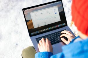 Professional viewing analytics dashboard on laptop screen showing data charts and metrics