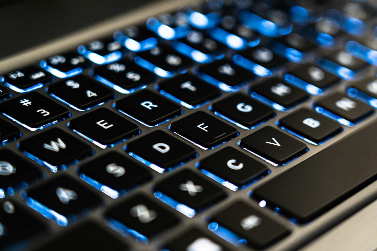 Person typing on laptop keyboard for content creation