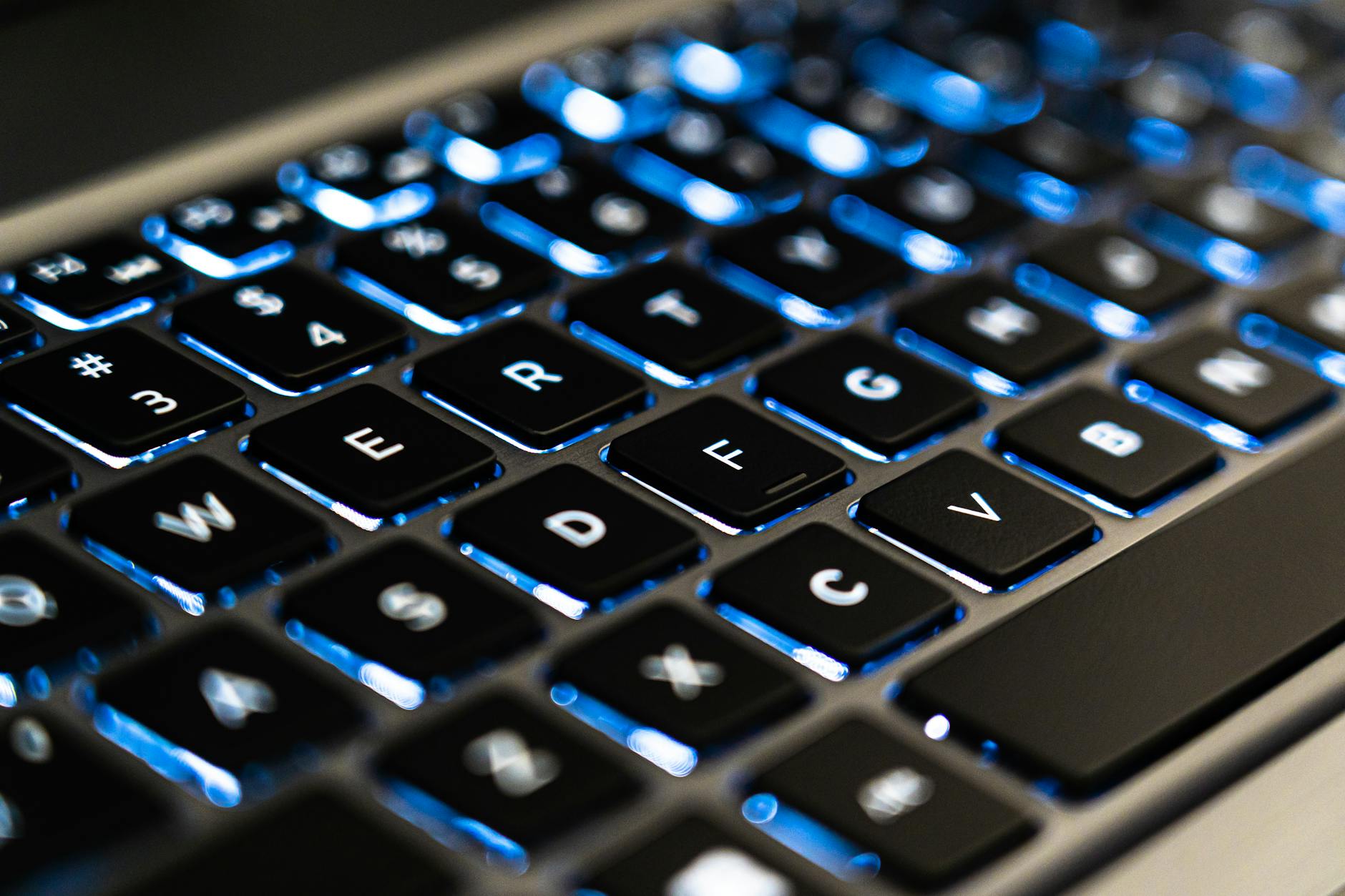 Person typing on laptop keyboard for content creation