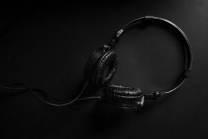 Person wearing headphones listening to music on smartphone
