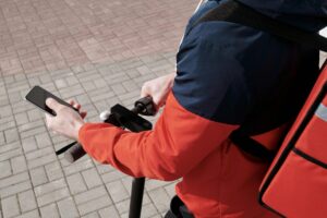Person using food delivery app on smartphone showing interface and ordering options