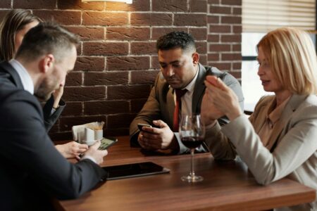Person using smartphone to manage business social media accounts