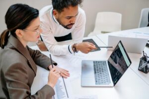 Person typing on laptop computer during online discussion or research session