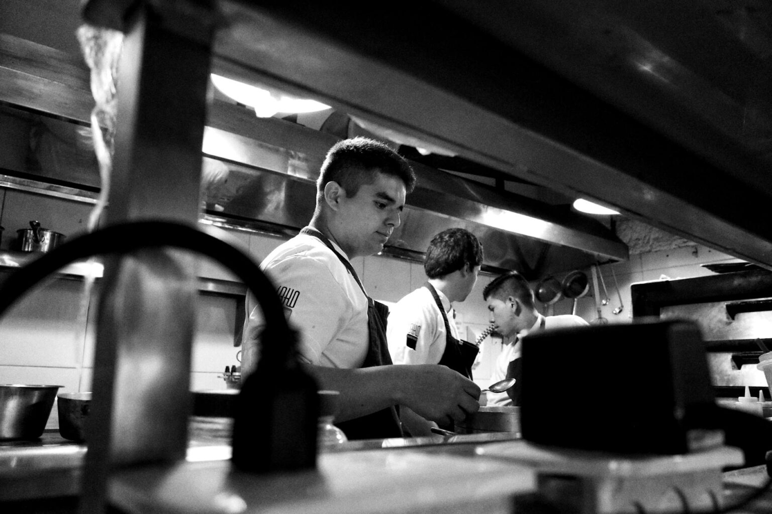 Clean commercial kitchen with chefs preparing fresh ingredients