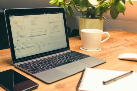 Professional workspace with laptop displaying LinkedIn interface for social media marketing