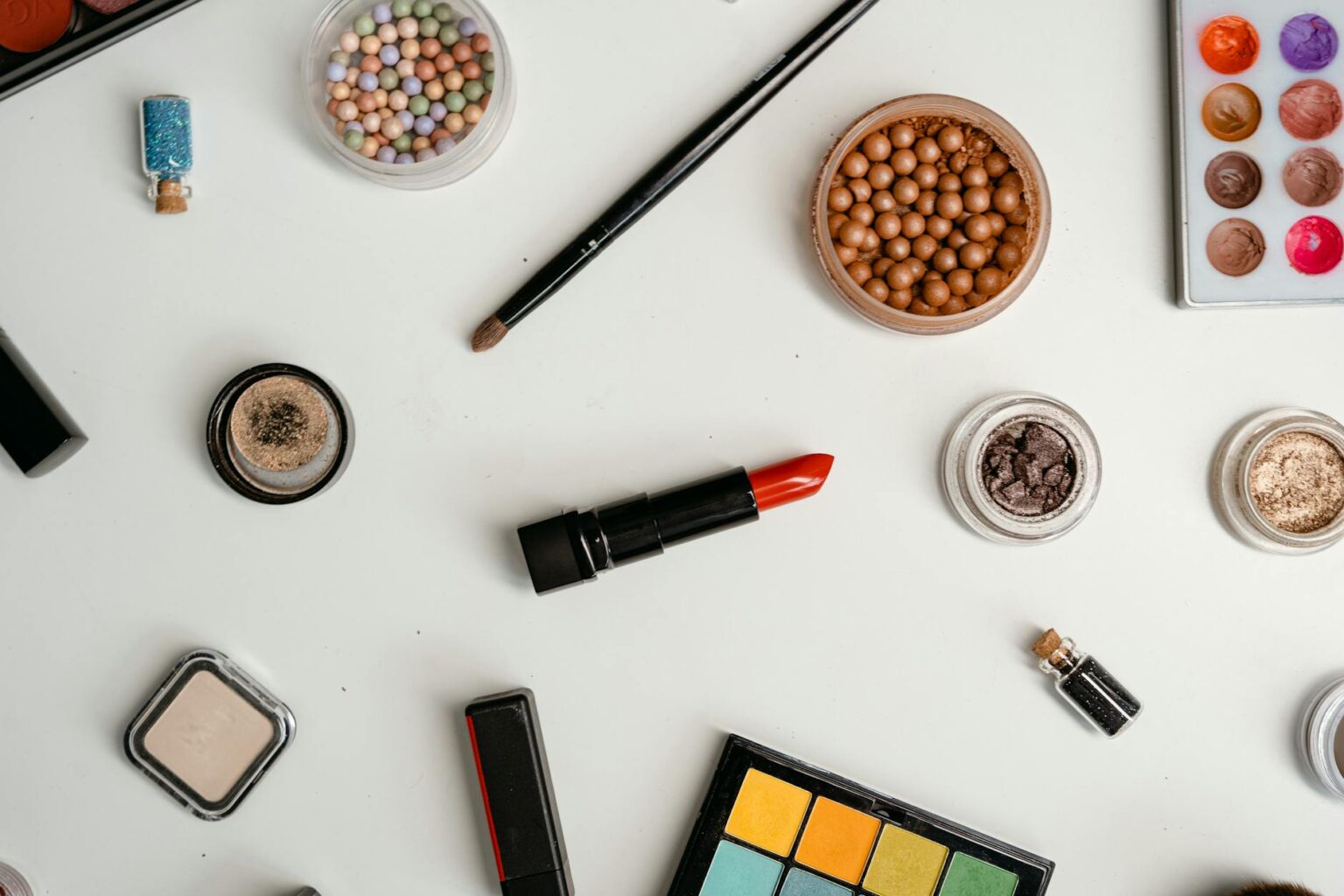 Collection of beauty products arranged on clean surface showing modern cosmetic packaging