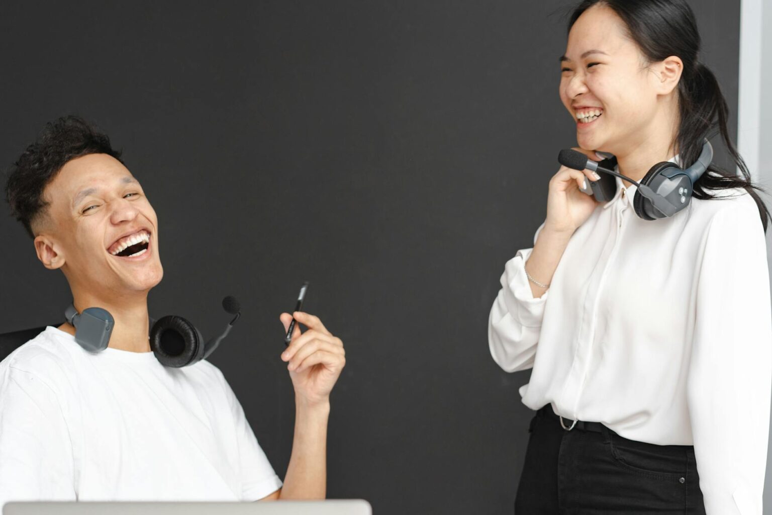 Customer service representative wearing headset while working at computer, representing personalized customer care