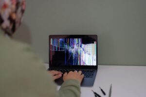 Person reading and responding to comments on laptop screen showing engagement metrics