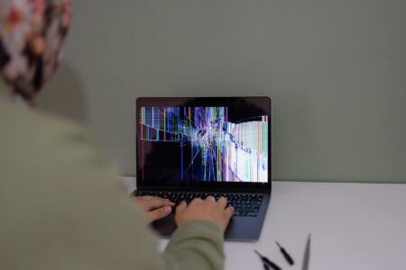 Person reading and responding to comments on laptop screen showing engagement metrics