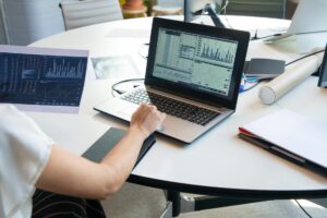 Person analyzing social media analytics and sentiment data on laptop screen