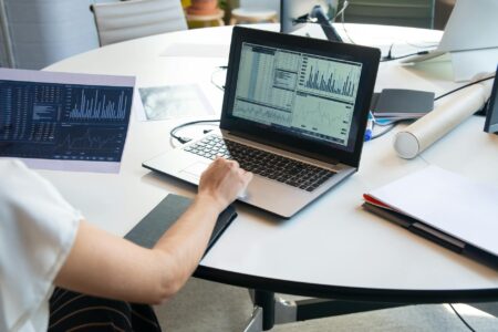 Person analyzing social media analytics and sentiment data on laptop screen