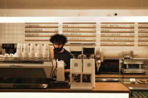 Modern coffee shop interior with customers using mobile devices