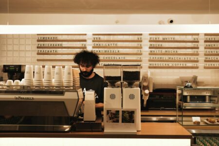 Modern coffee shop interior with customers using mobile devices