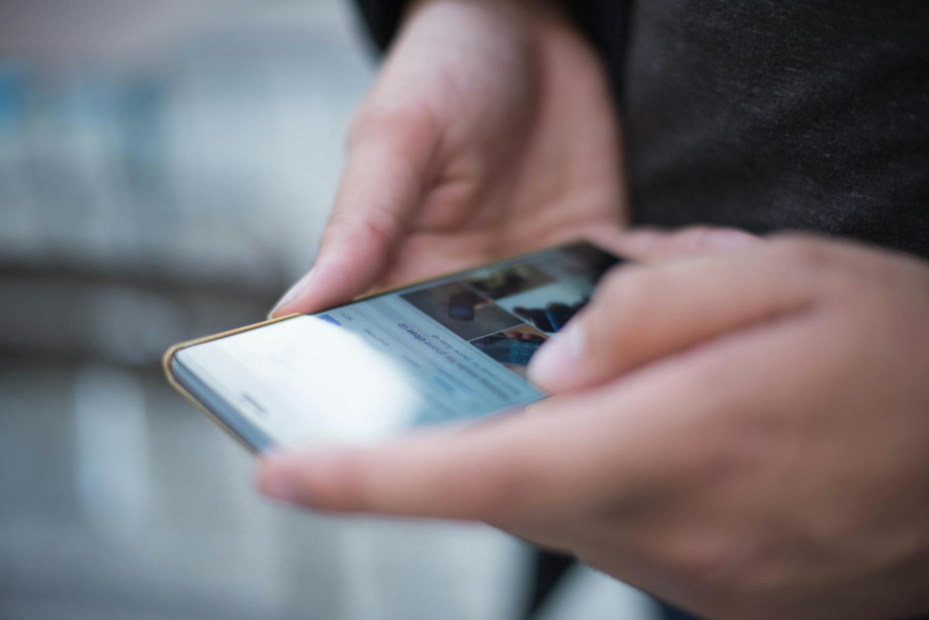 Smartphone displaying TikTok app interface with video content and engagement metrics visible on screen