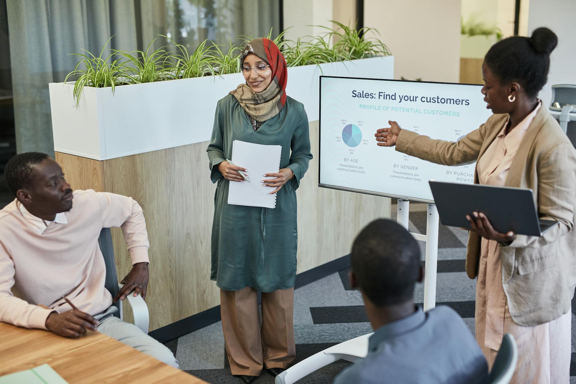 Business team reviewing marketing strategy documents and charts in modern office