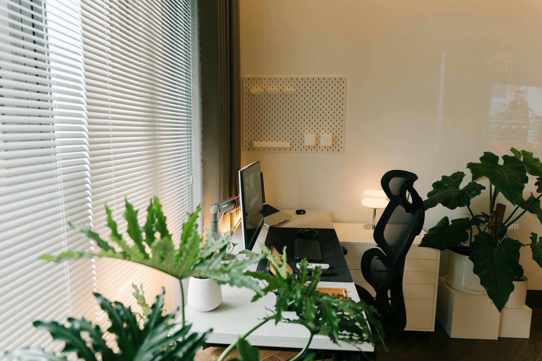 Authentic workspace with laptop and coffee, showing real work environment for behind-the-scenes content