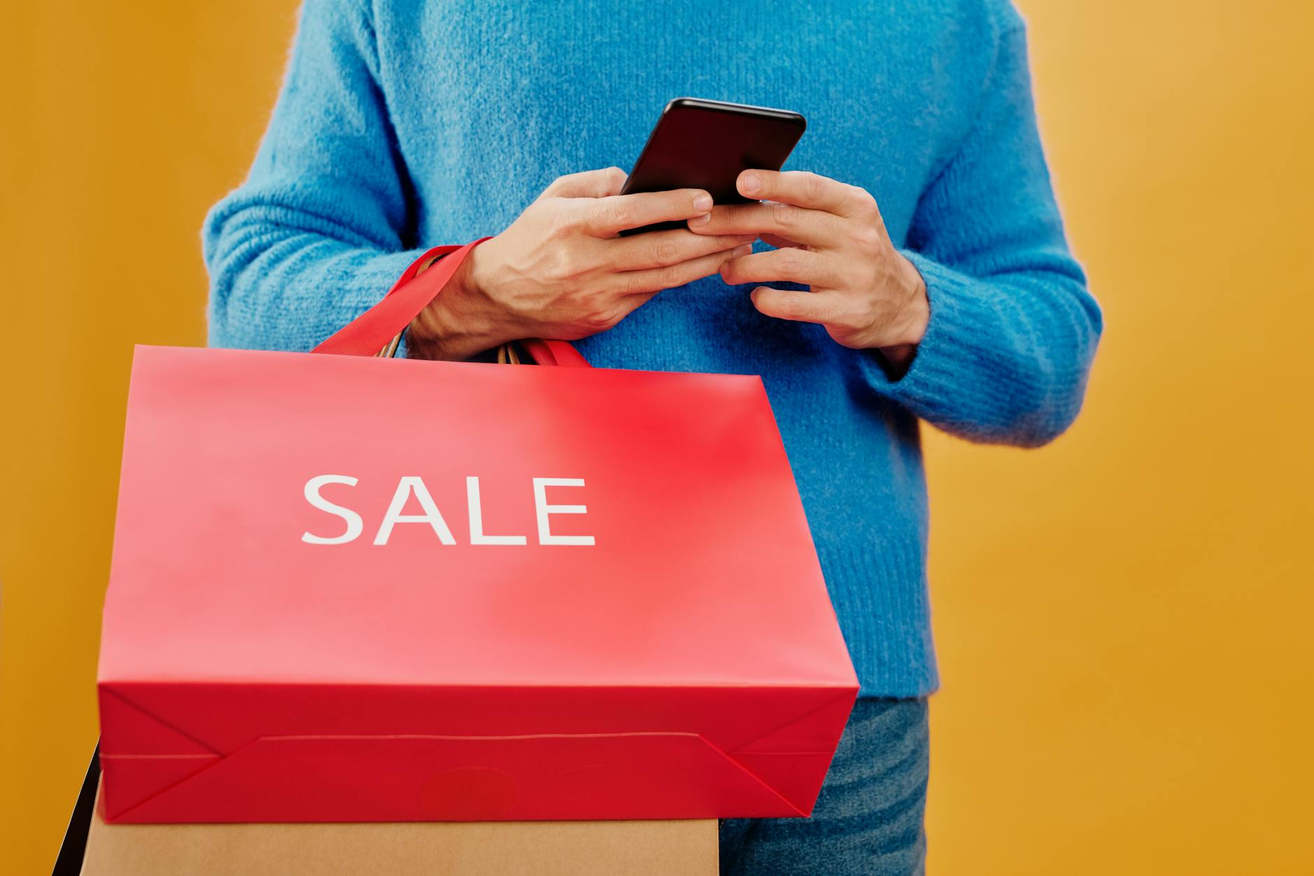 Person using smartphone to browse and shop for seasonal products on mobile Pinterest app