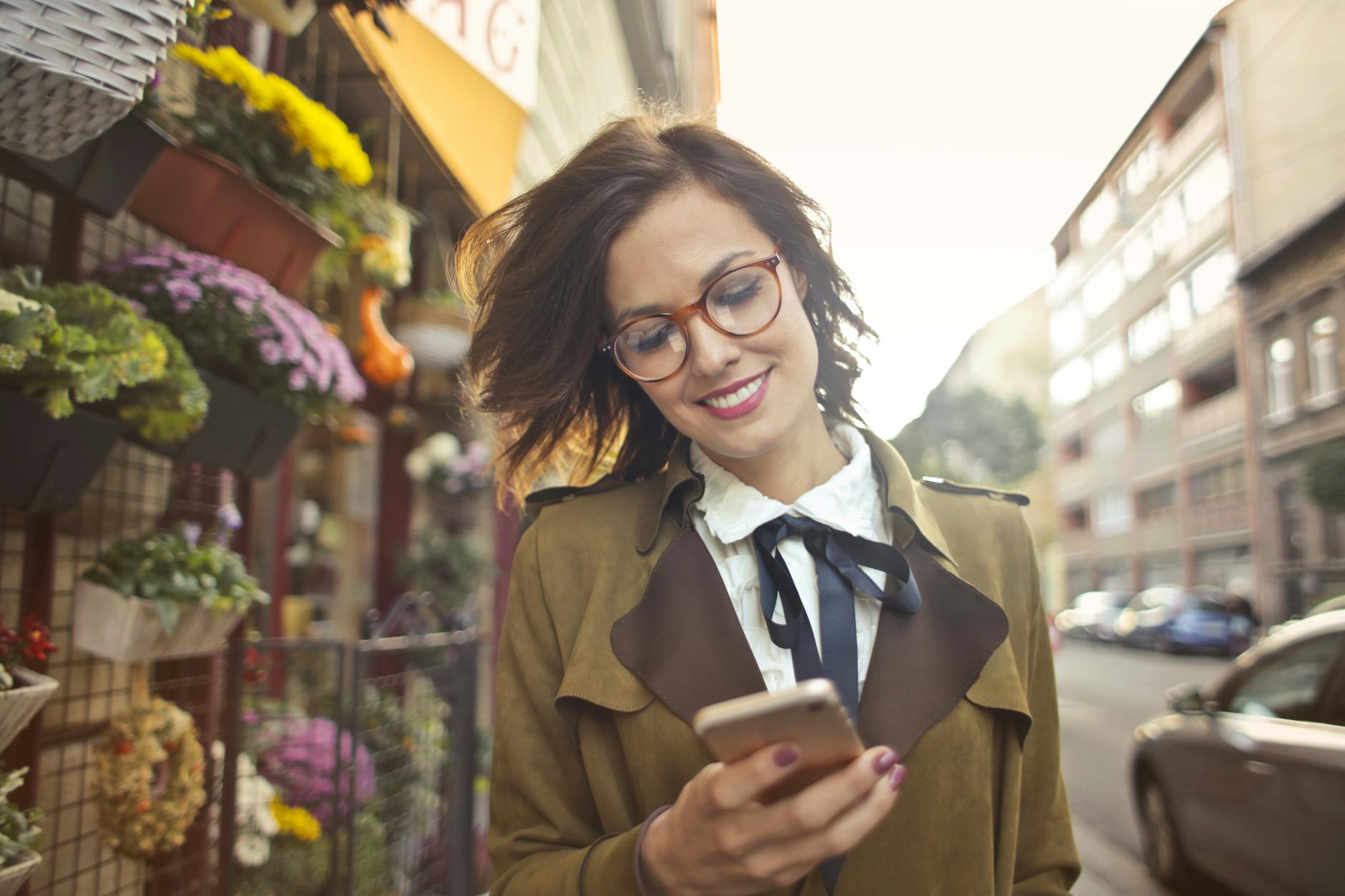 Person using smartphone for online shopping with product images on screen