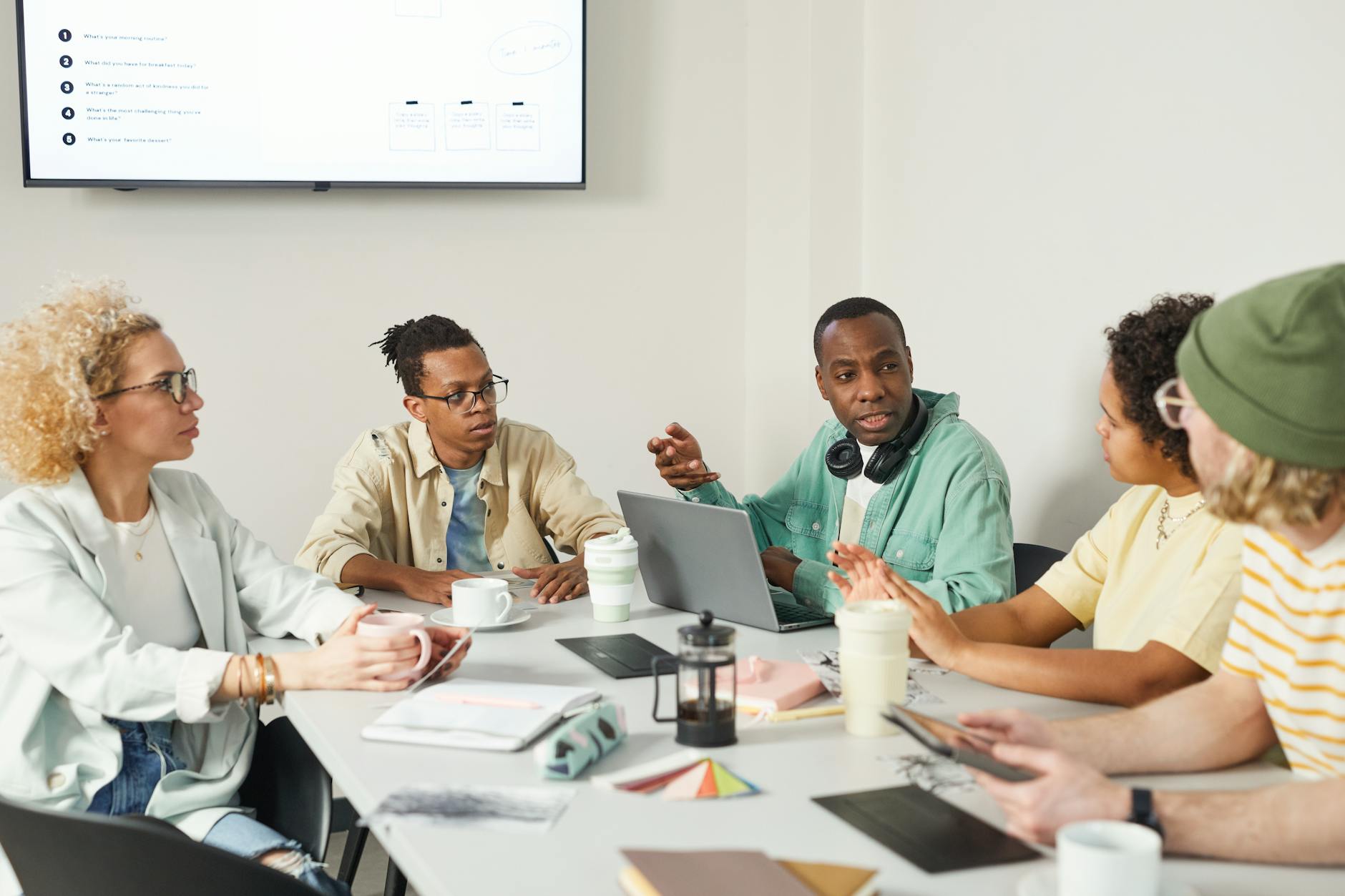Business team collaborating around conference table discussing social media strategy