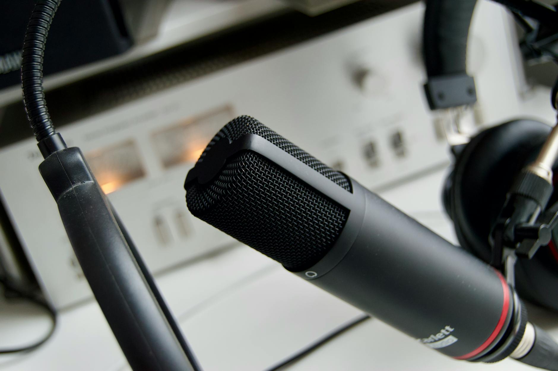 Podcast recording setup with microphone and headphones in professional studio environment