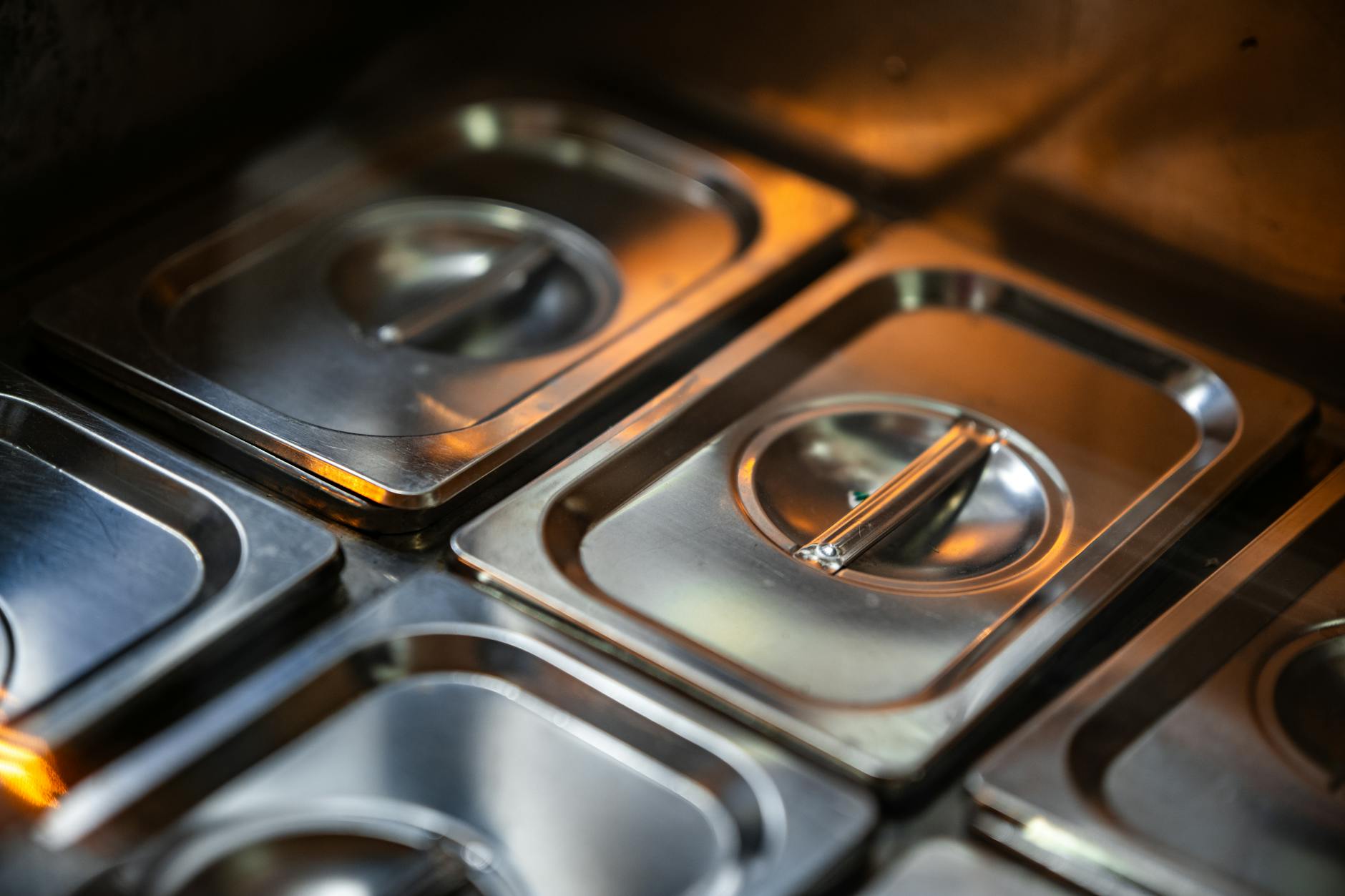 Professional commercial kitchen with stainless steel equipment and prep stations