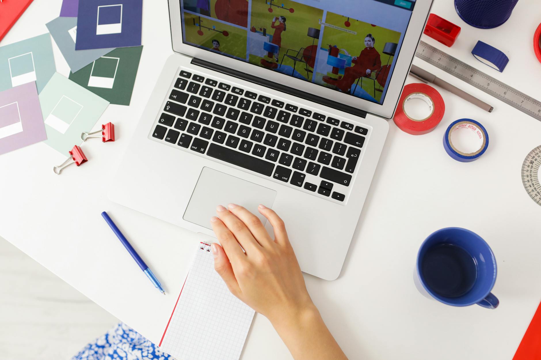 Modern creative workspace with computer and design materials