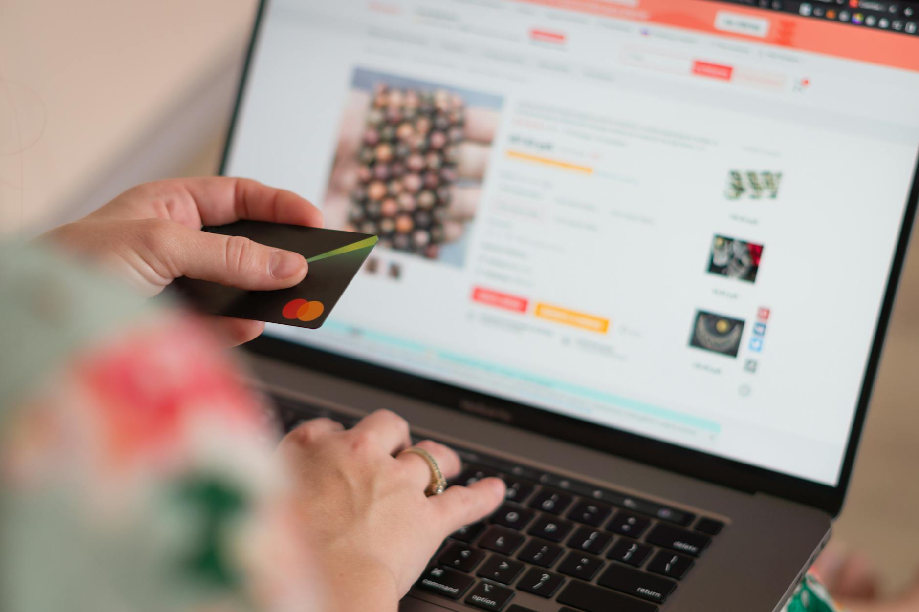 Woman making online purchase using laptop and credit card at home