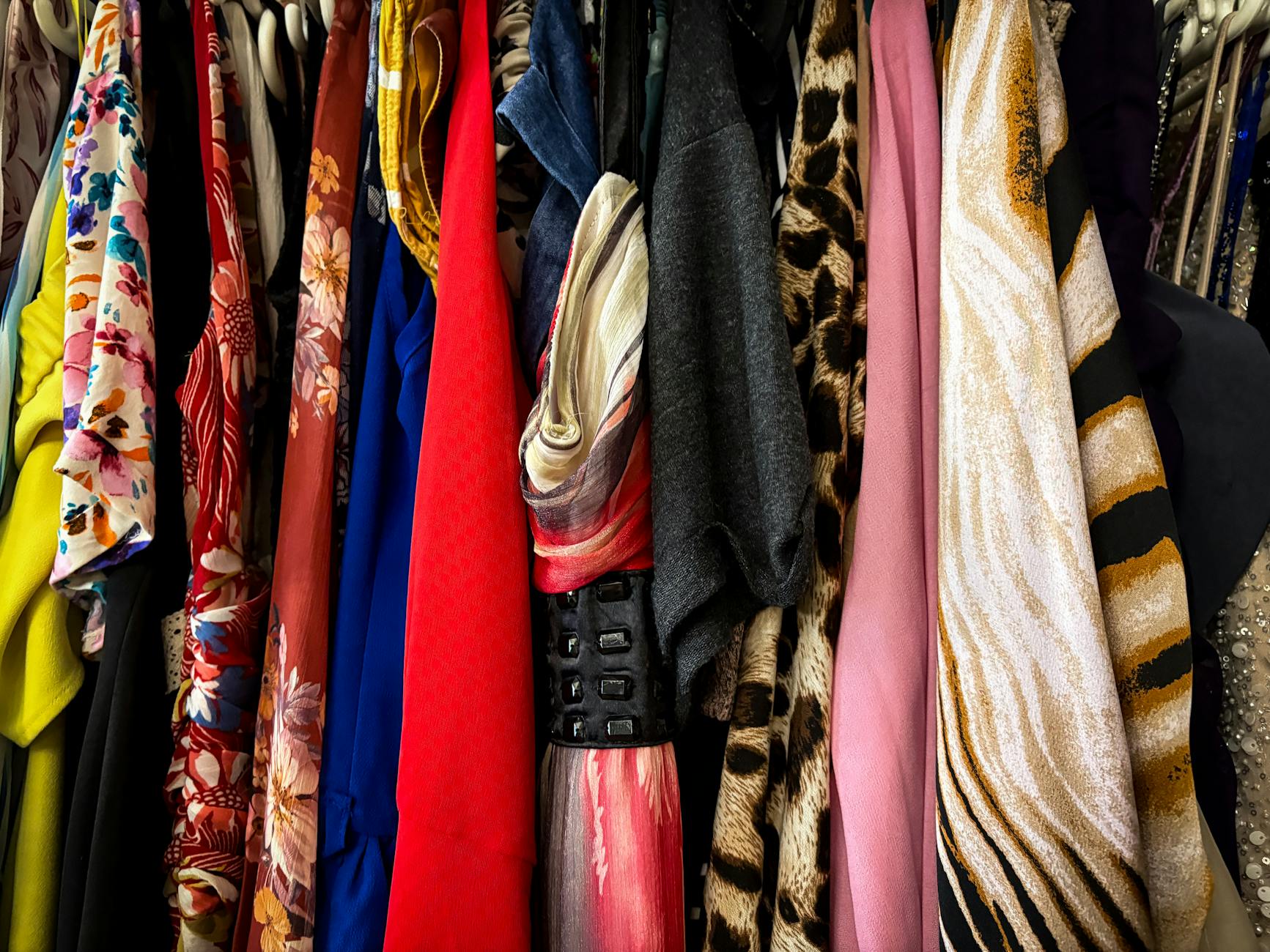 Person examining clothing with focus on quality and sustainability