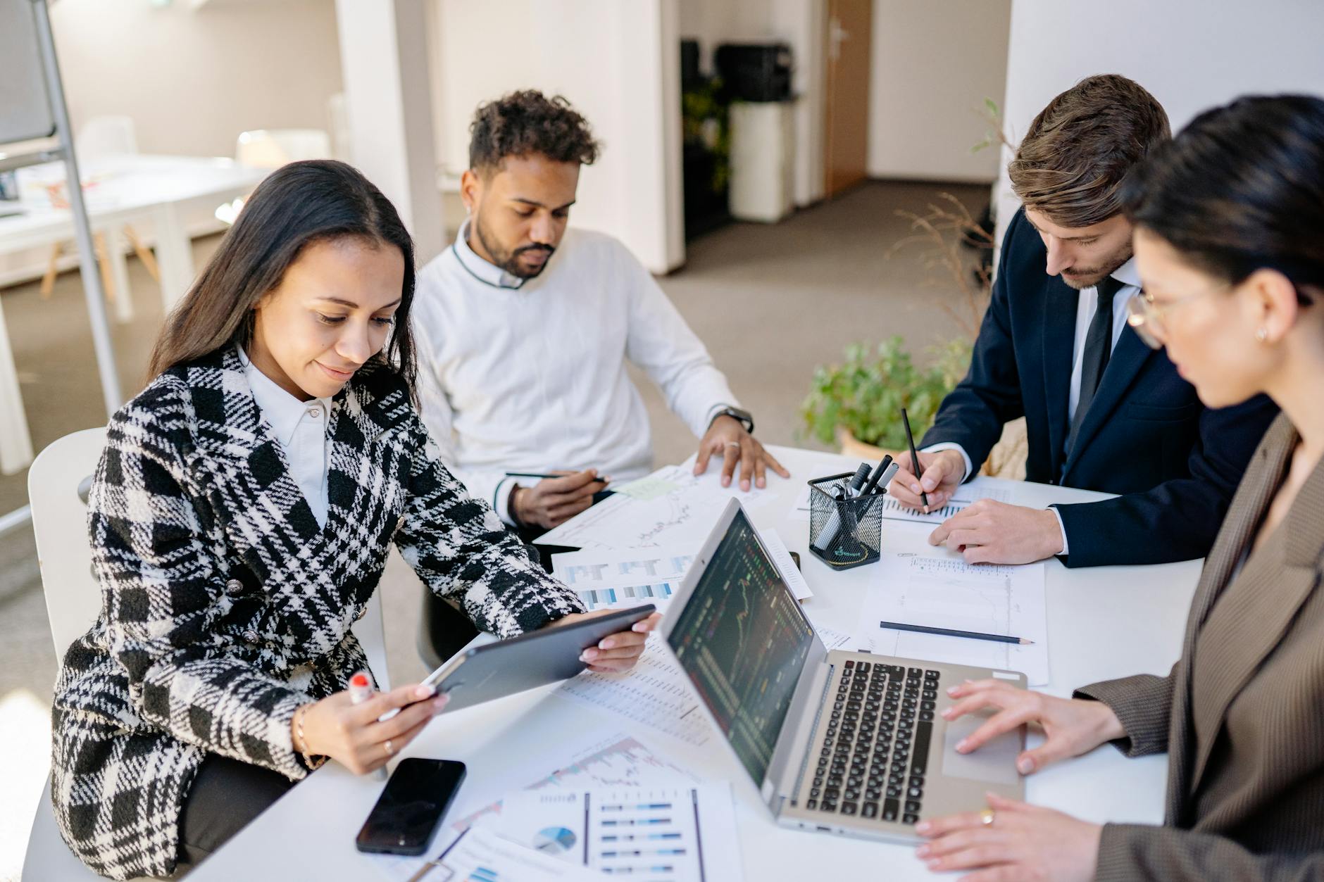 Marketing team reviewing performance reports and analytics data during business meeting