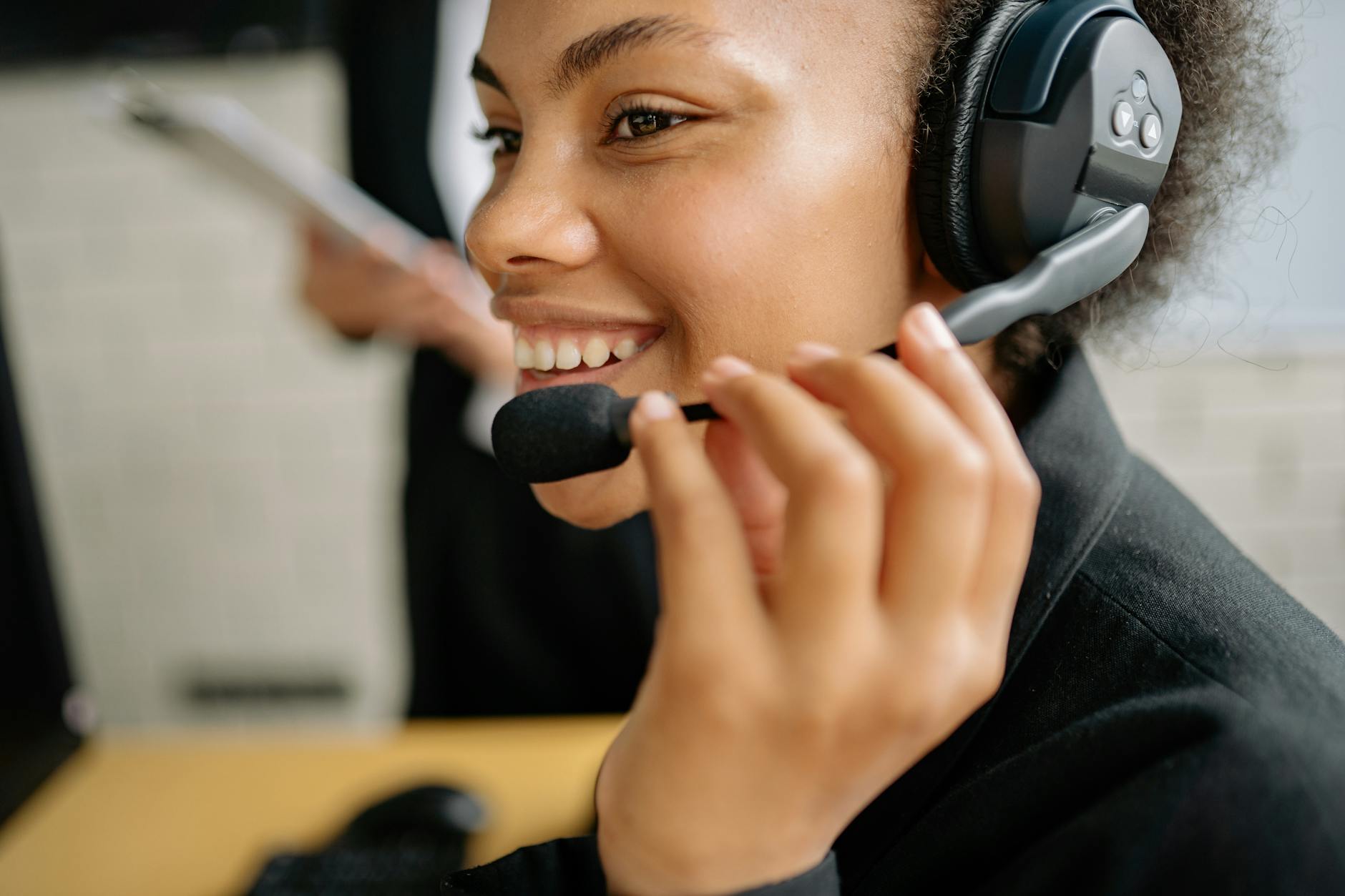 Professional customer service representative working at desk with headset and computer for client support