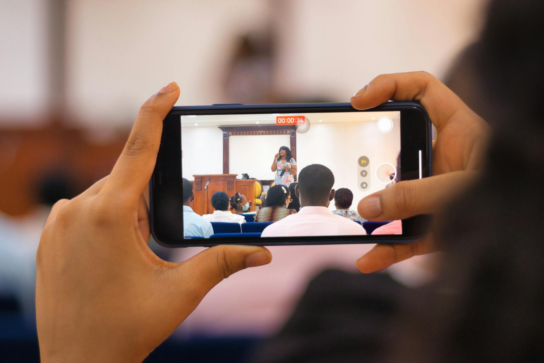 Hand holding smartphone recording vertical video for social media