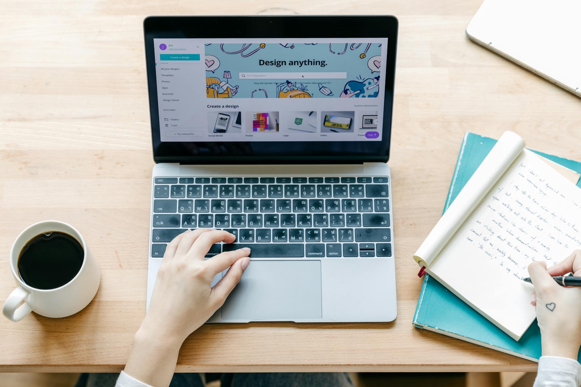 Open laptop on desk with coffee cup showing social media content creation workspace