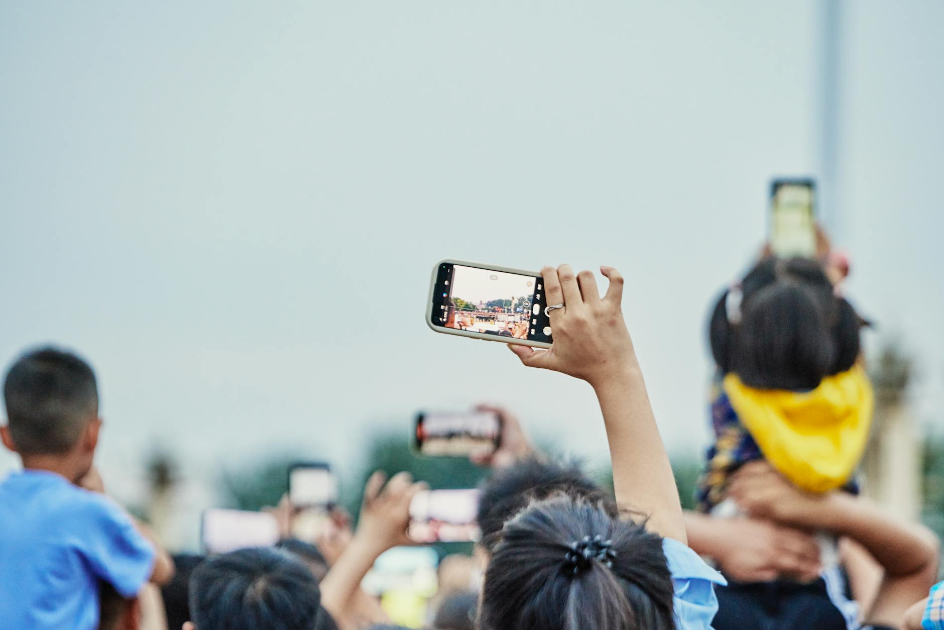 Hand holding smartphone displaying Instagram stories interface with engagement statistics