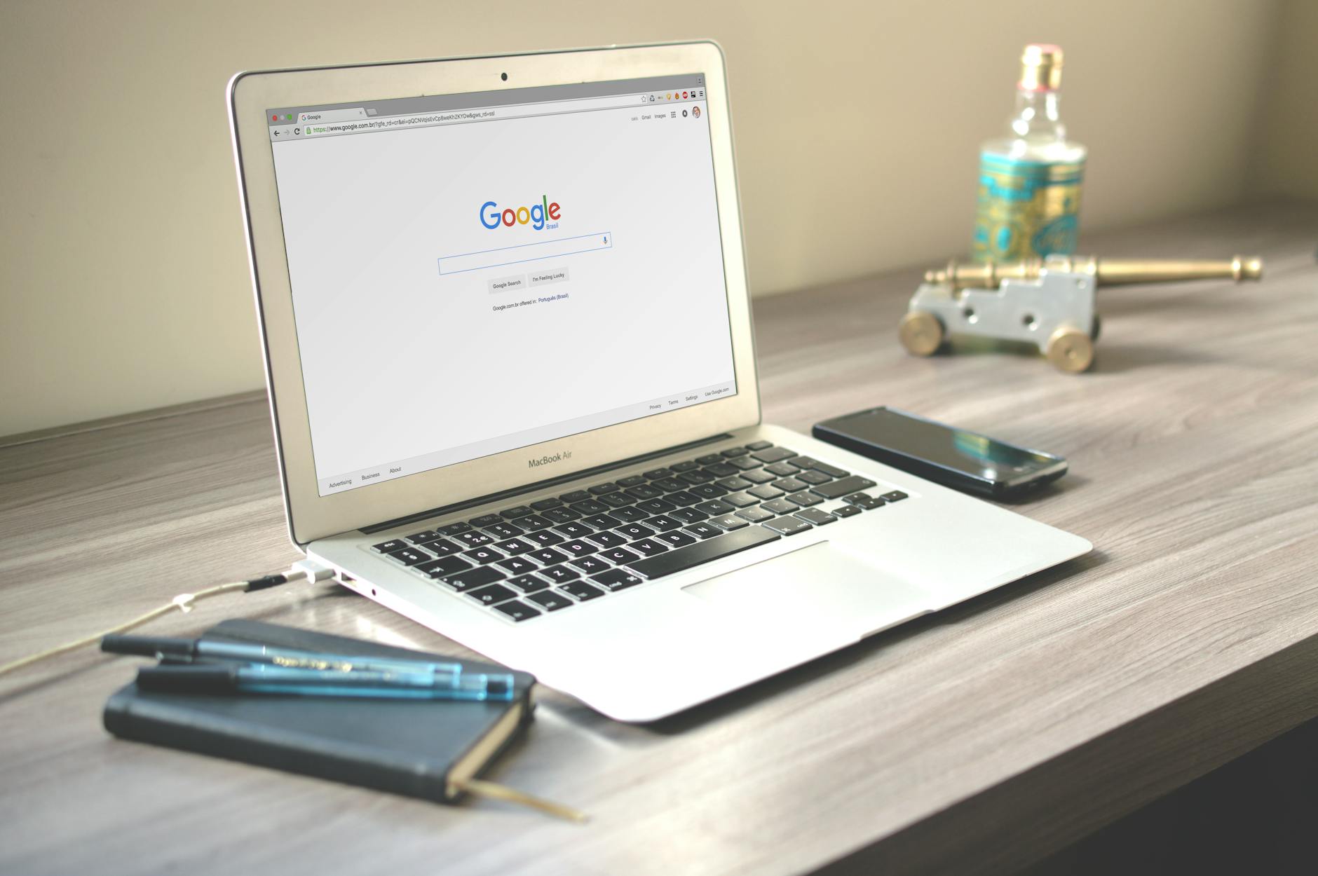 Marketing professional reviewing analytics on a laptop and smartphone at a desk