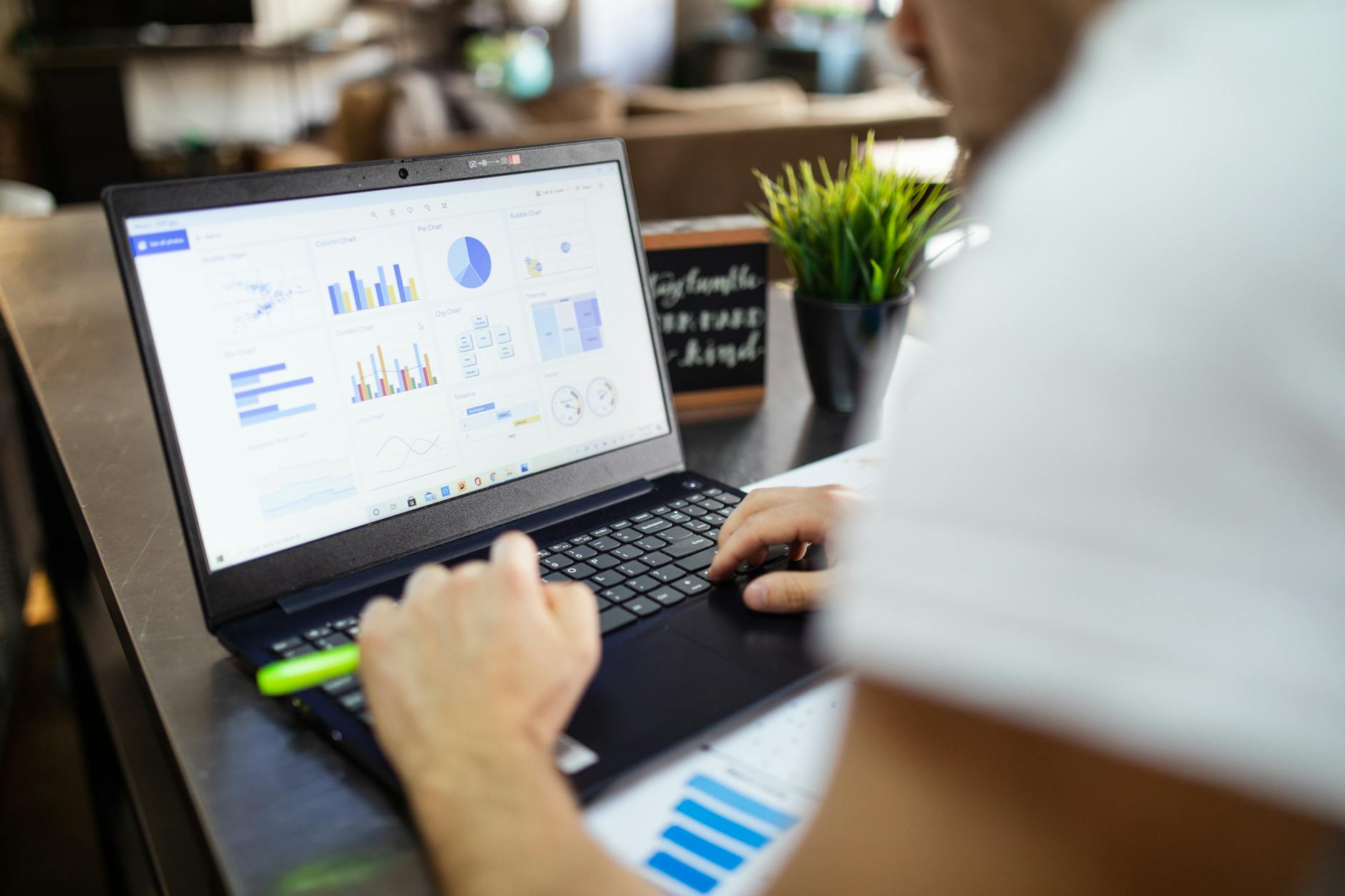 Computer screen showing spreadsheet with data columns and charts