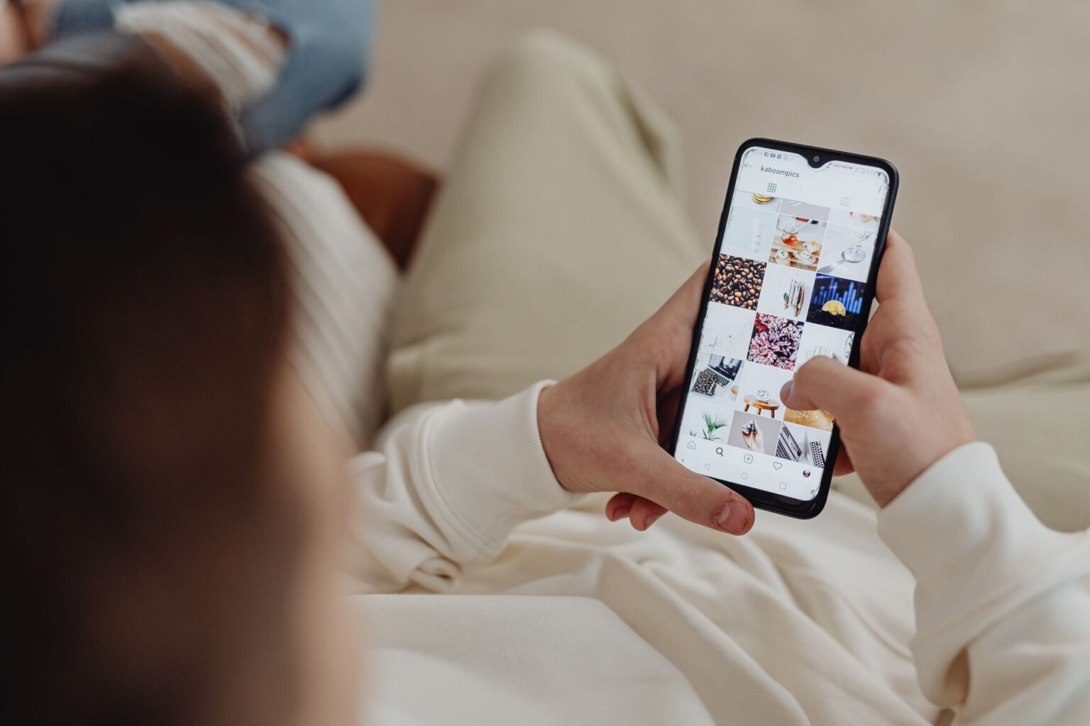 Person scrolling through a social media feed on a smartphone