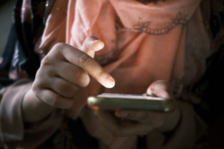 Person scrolling through short video content on a smartphone
