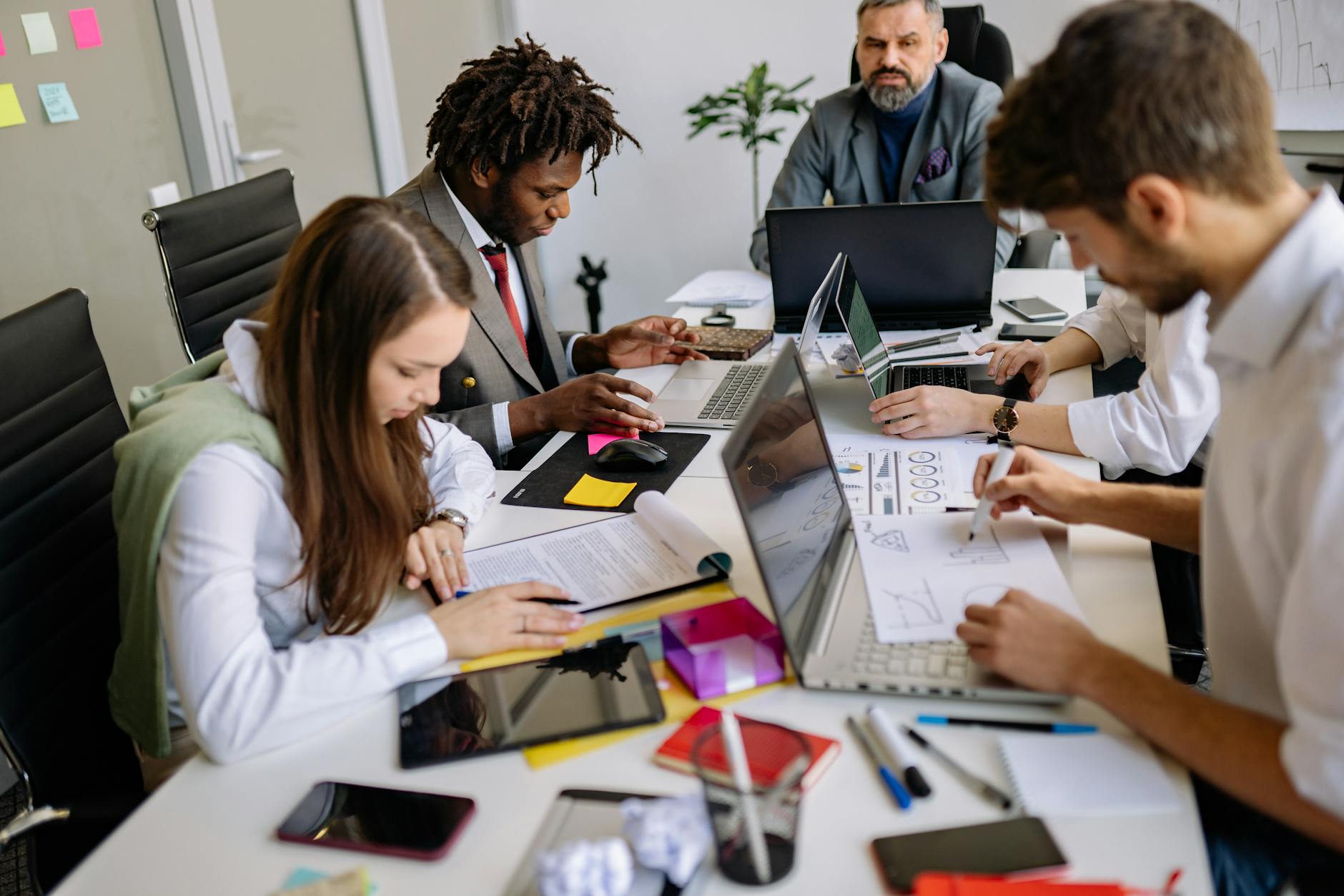 Small marketing team reviewing digital ad creatives on a screen