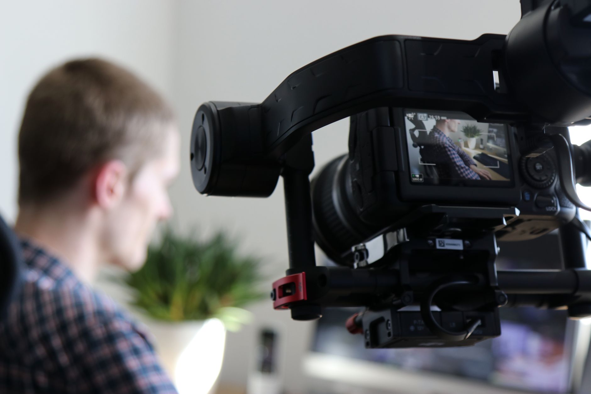 A content creator filming a short-form video in a minimal home studio setup