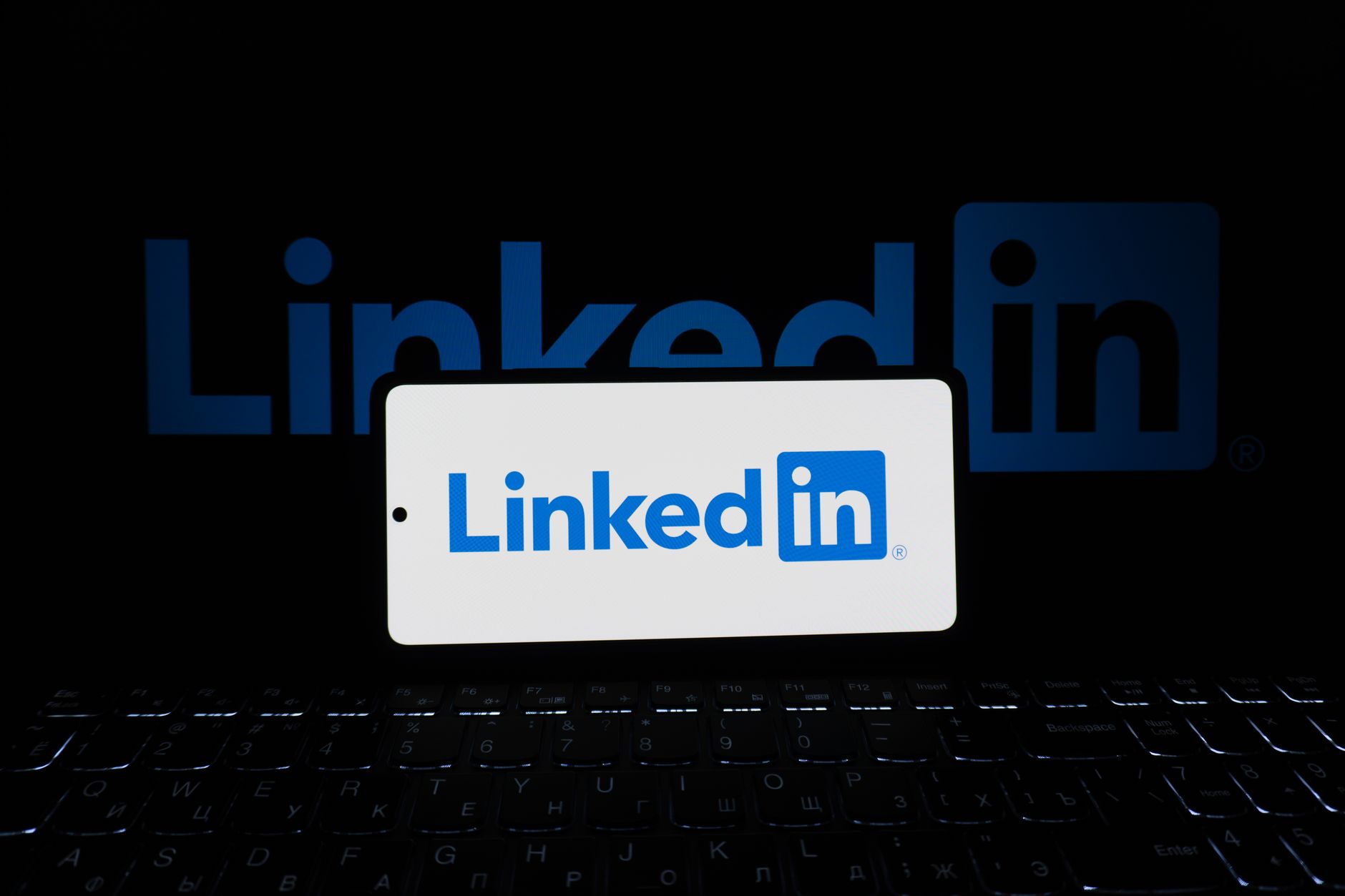 Person browsing LinkedIn on a laptop in a professional workspace