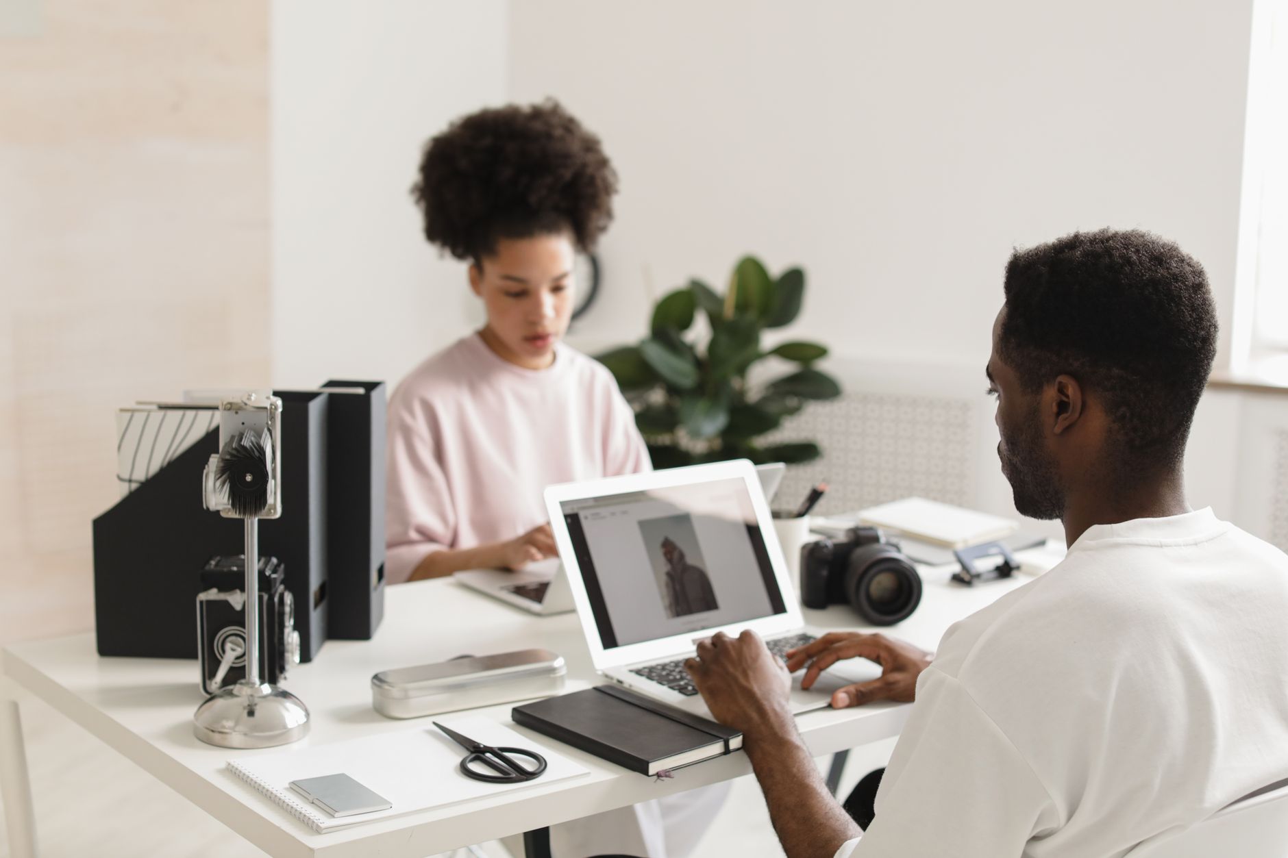 Content creator working at a home office desk with multiple screens