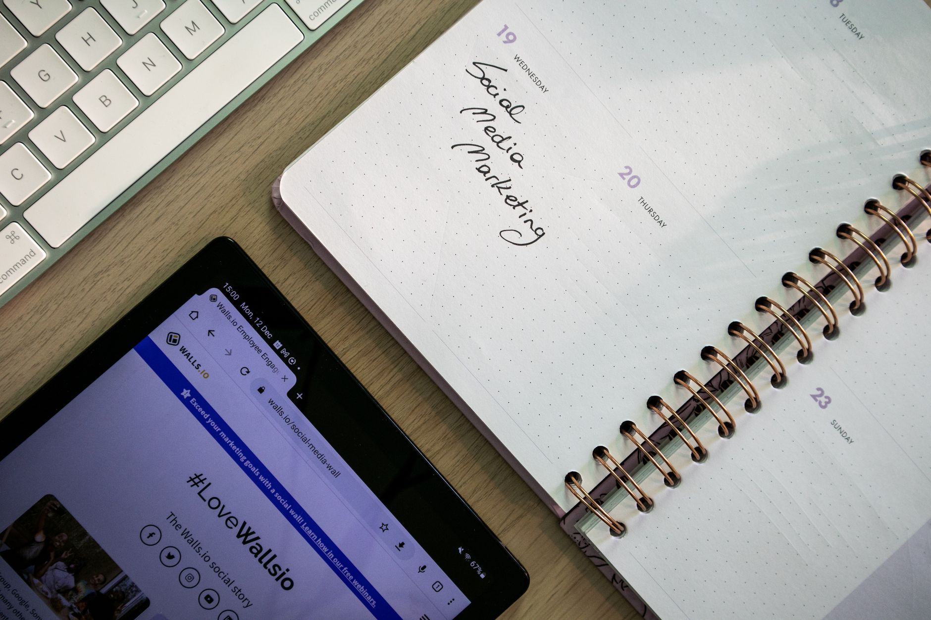 A marketing professional reviewing a social media content schedule on a tablet