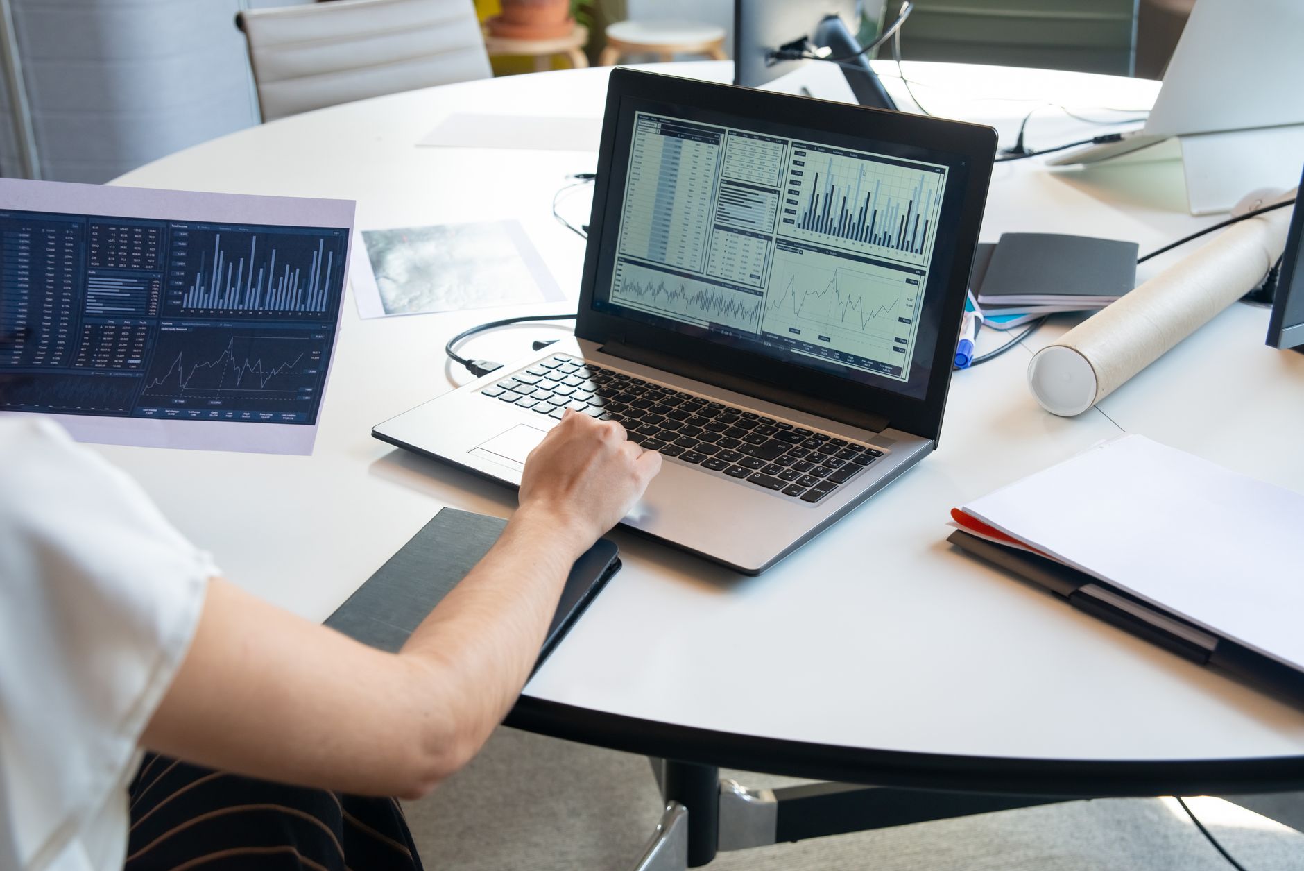 Marketer reviewing performance data on laptop at a desk