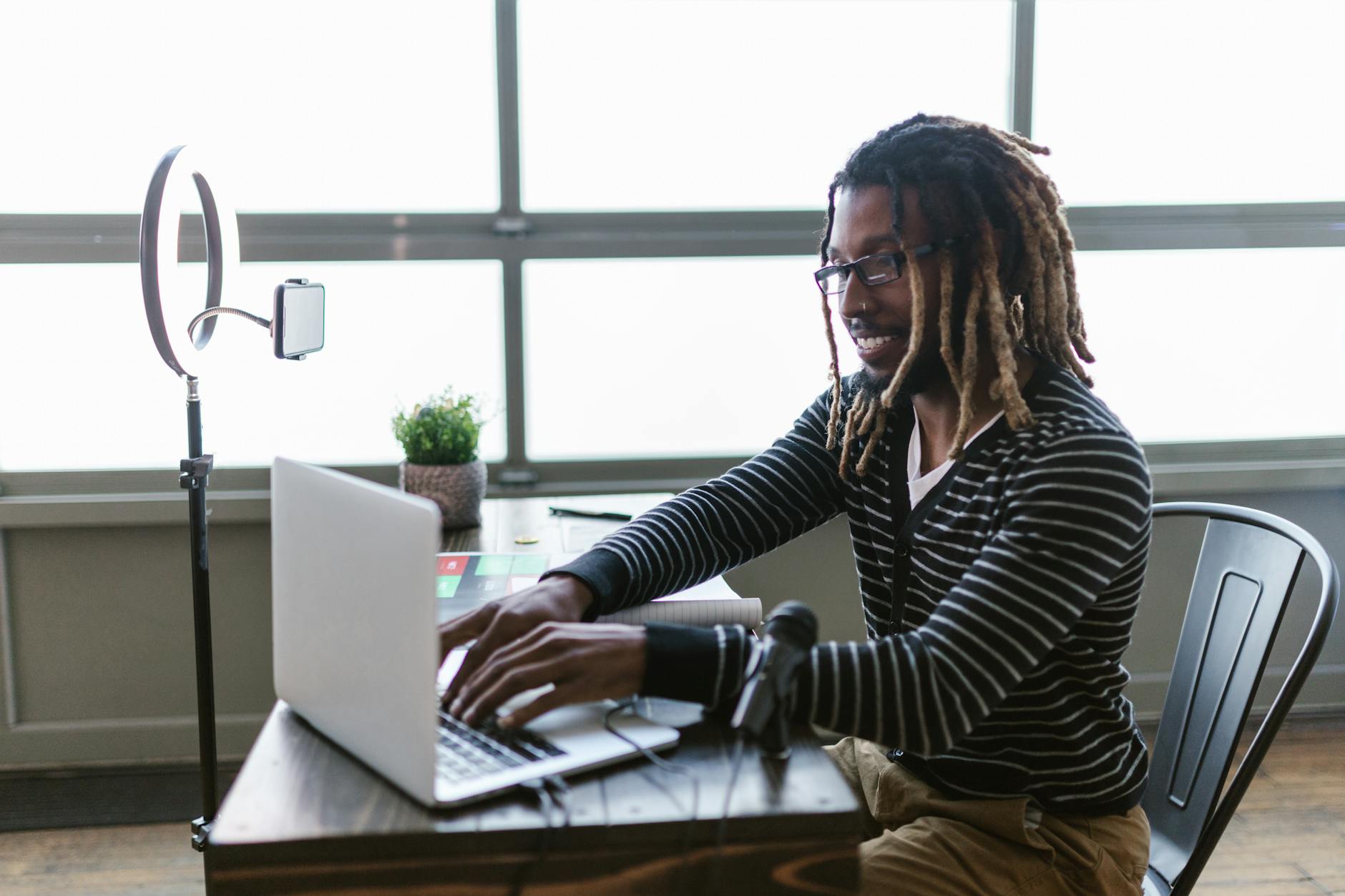A content creator reviewing social media analytics on a laptop at a desk