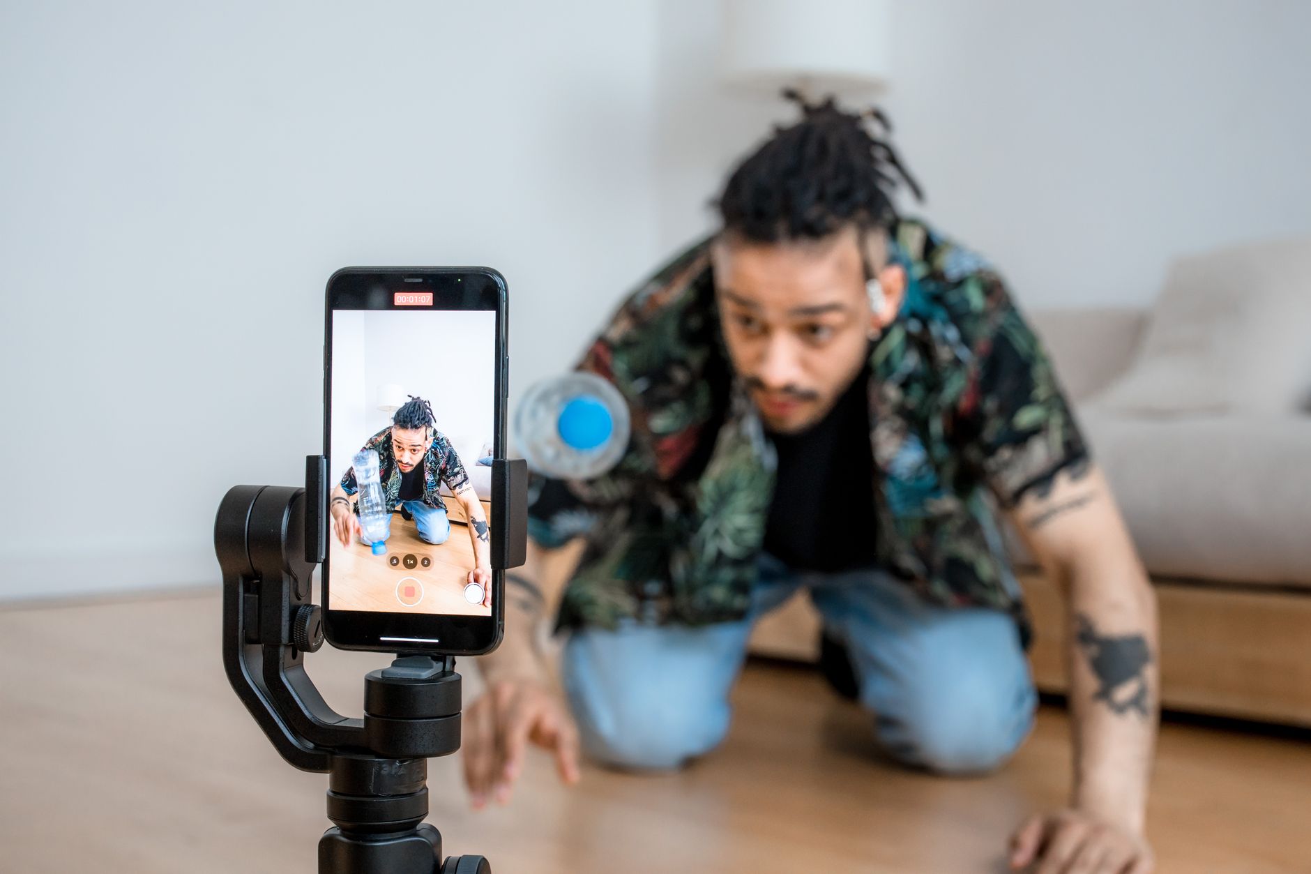 A content creator filming a talking-head video with a camera setup